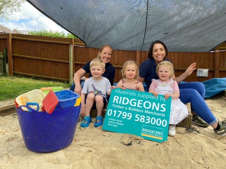 Nursery-managers-Caroline-and-Barbs-in-the-newly-refreshed-sandpit-with-children-Bobs-Paige-and-Sadi