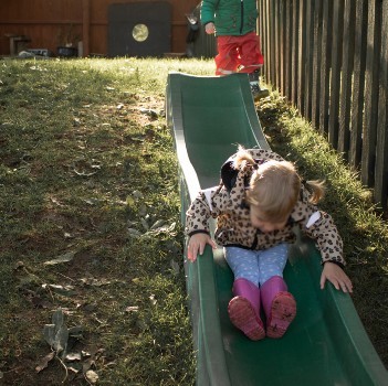 girl-on-slide-in-garden