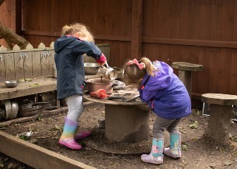 girls-making-potions-in-the-mud-kitchen