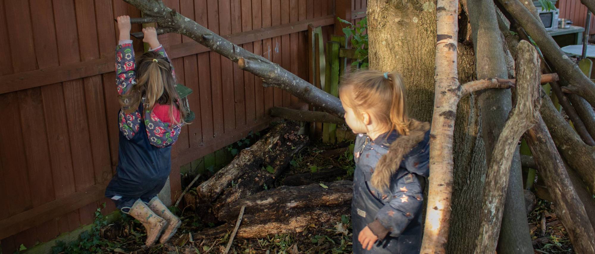 girl-swings-off-tree-branch-in-garden